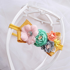 Handmade flower made out of fabric cloth textile in beautiful soft pastel colors that can be used as hair accessory, decoration, and embellishment
