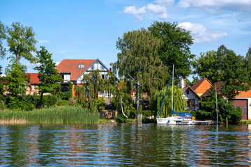 Fototapeta na wymiar Harbor village Rheinsberg-Brandenburg with traditional houses on a sunny day in summer, Germany