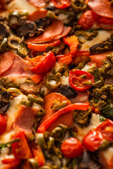 close up view of delicious Italian pizza with vegetables and salami
