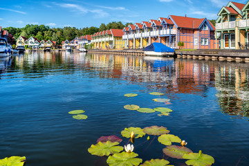 Harbor village Rheinsberg-Brandenburg with traditional houses on a sunny day in summer, Germany - obrazy, fototapety, plakaty