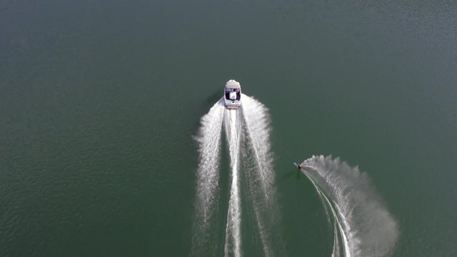 Aerial view of water skiing action on a lake in Austria during sunny weather
