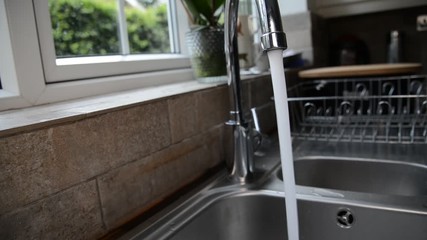 Turning Chrome skink tap on in england, uk