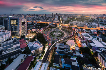 Fototapeta na wymiar Cityscape of Victory Monument with car traffic on roundabout road at Bangkok, Thailand