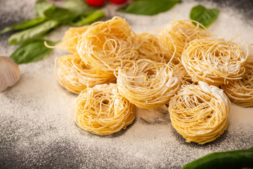 raw Italian Capellini with flour and black pepper