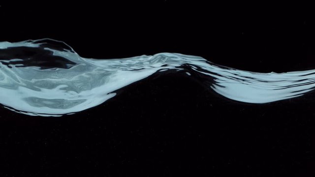Super slow motion of waving water isolated on black background. Filmed on high speed cinema camera, 1000 fps.