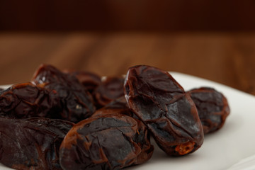 dates without seeds on wooden table and blur background