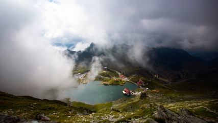 Obraz premium alea Lake covered by fog, Fagaras Mountains, Romania in the summer.