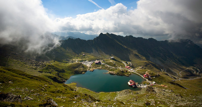 alea Lake covered by fog, Fagaras Mountains, Romania in the summer.