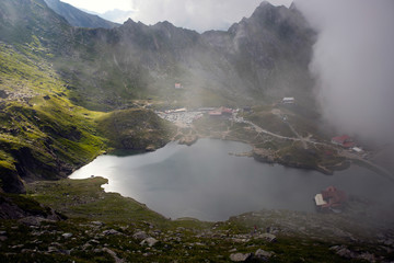 Fototapeta premium alea Lake covered by fog, Fagaras Mountains, Romania in the summer.
