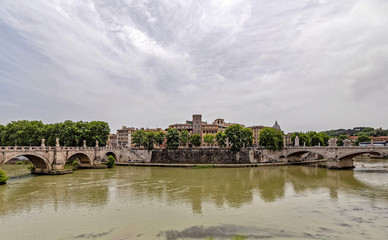 Fototapeta premium Rome Italy, Saint Angelo and Vittorio Emanuele II bridges on Tiber river panoramic view under impressive sky
