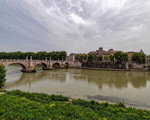 Rome Italy, Saint Angelo bridge on Tiber river under impressive sky