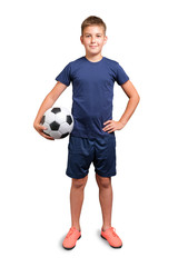 Kid in sport uniform holding a classic soccer ball, looking at camera and smiling isolated on white...