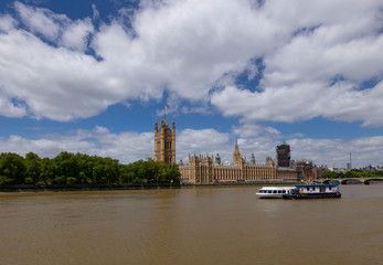 Naklejka premium London/ United Kingdom - 06.29.2020: A view of the Parliament and river Thames on a sunny day.