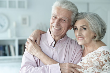 Portrait of cheerful senior couple at home