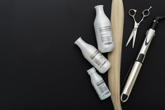 L'oreal Professionnel Paris Serie Expert Silver Hair Professional Products.Loreal Shampoo Cream Mask For Hair.Professional Hairdresser Scissors,hair Iron Babyliss,blonde On Black Background.Flat Lay