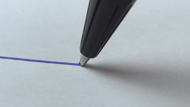 auto pen draws a straight line on a white paper background, macro photography