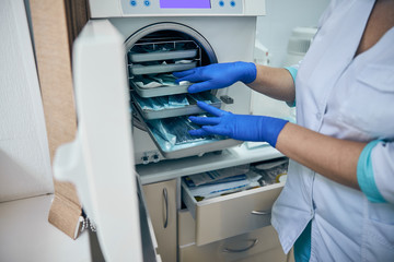Sterilizing medical equipments in autoclave in a medical clinic