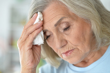 Close up portrait of sad ill senior woman