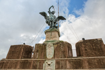 Fototapeta na wymiar The magnificent statue of the Archangel Michael. Bronze statue of Michael the Archangel on the top of the Castel Sant'Angelo, modelled in 1753 by Peter Anton von Verschaffelt, Rome, Italy