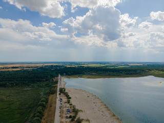 Photo from a flying drone, sandy beach by the sea on a sunny day in summer