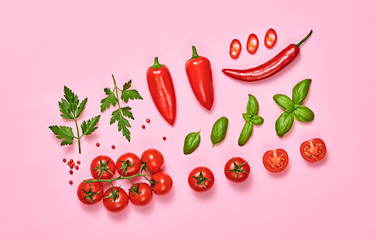 Tomato, basil, spices, bell chili pepper. Vegan diet food, creative composition on pink. Fresh basil, herb, cherry tomatoes layout, cooking sauce colorful concept, top view.