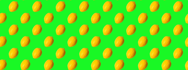 Seamless Pattern made with yellow lemon fruit on green background.