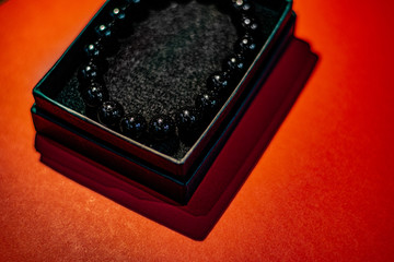 Black beads with red background