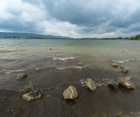 Fototapeta premium Rocks near the shore of Untersee lake, in Radolfzell, Germany