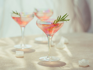 Glass of strawberry cocktail or mocktail, refreshing summer drink with crushed ice and sparkling water on light background. Beverage photography.