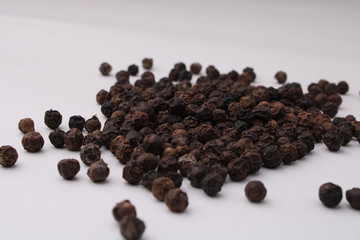 Black pepper placed on a white background.