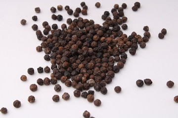 Black pepper placed on a white background.