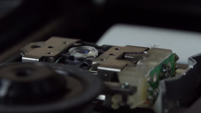 In a DVD player, when an empty disc tray is closed, the red laser tries to recognize the disc. Macro. Close up. Low depth of field