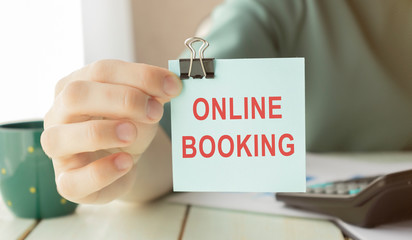 Text Online Booking written on a card, Business concept. Internet concept.