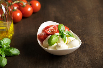 Italian salad Caprese in a white plate.