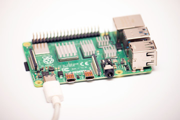 Kiev, Ukraine - August 13th, 2020: Close-up of a powered single-board microcomputer Raspberry Pi 4 Model-B on a white background.