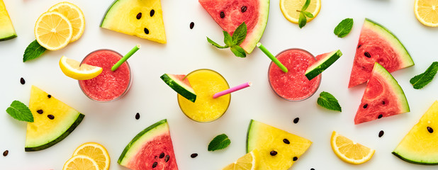 Watermelon, lemon colorful pattern background. Fresh red yellow watermelon slices, citrus wallpaper, top view. Lemonade in glass, creative concept, fashionable trendy summer beverage, flat lay