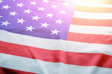 Fototapeta na wymiar Flag United States of America in bright rays sun.