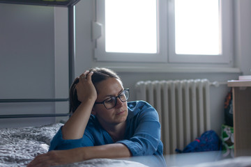 Obraz premium Depressed woman awake in the night, she is exhausted and suffering from insomnia. sleep disorder and stress concept.