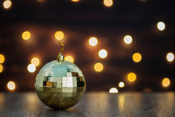 Christmas golden sphere in a bokeh lights background