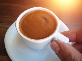 man holding traditional turkish coffee served with porcelain cup