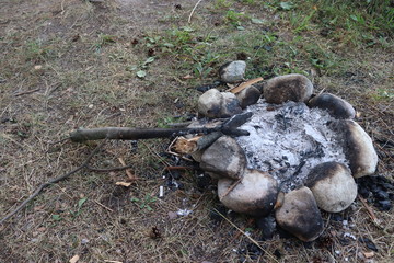 Naklejka na ściany i meble lots of stones on barbecue spot with burned out grass