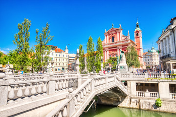 Ljubljana City Center during a Sunny Day overlooking the Triple Bridge and Beautiful Franciscan Church - obrazy, fototapety, plakaty