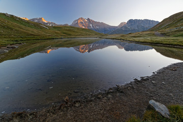 Refelctions on a mountain lake at sunrise