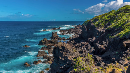 Fototapeta na wymiar A view towards Black Rocks on the Atlantic coast of in St Kitts
