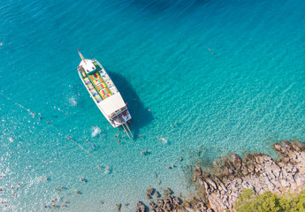 Tourist ship. Many tourists swim in the turquoise sea. Aerial View
