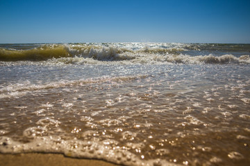 The rough sea. High waves. View from the sandy beach