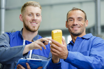 two male engineers with multi meter