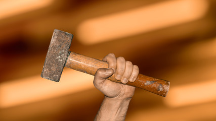 hand with hammer against blurred motion background