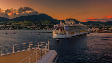 A cruise ship leaves Basseterre Bay at sunset in St Kitts