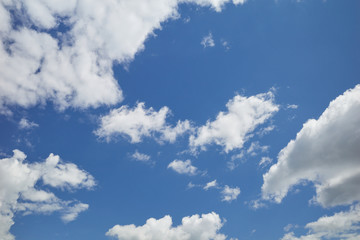 Clouds floating overhead in the blue sky